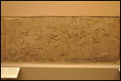 Смотр пленников (см. также след. фото). Нимруд, ок. 865-860 гг. до Р.Х. Британский музей. WA 124537. Царь Ашшурнацирпал II, спустившись с колесницы, осматривает пленников. Ассирийский воин, который целует ноги царя, вероятно, один из тех, кто отличился в бою. Продолжение изображения процессии на панели справа (см. след. фото).